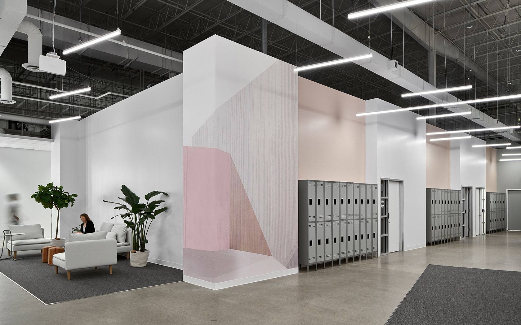 Soaring ceilings, industrial details, can crisp white furnishings create ambiance for Postmates Nashville headquarters.