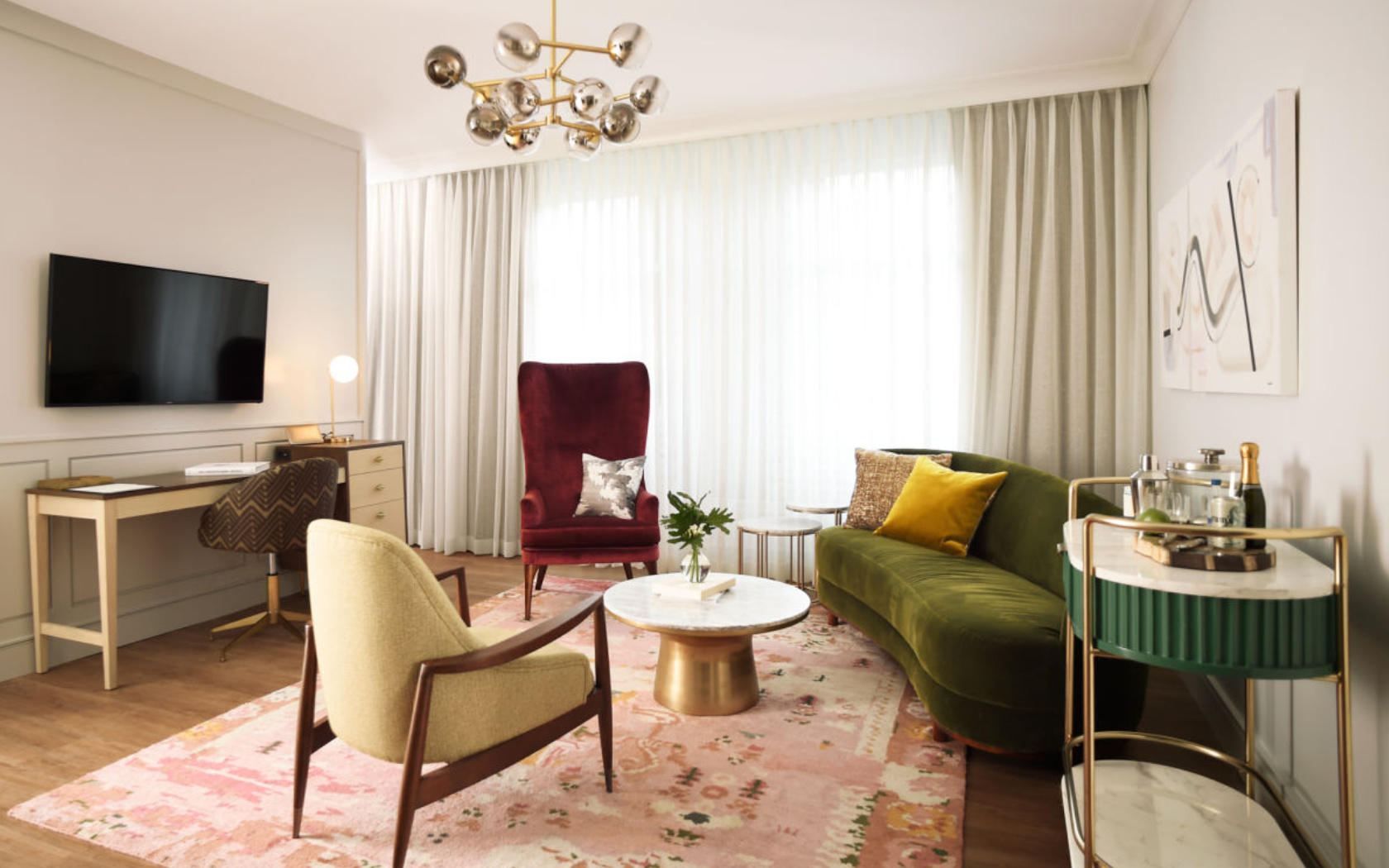 Plush velvet upholstered pieces create a warm and relaxing environment for a West Elm hotel room.