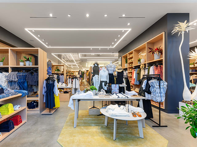 New oak shelving units are illuminated by VMAD designed ceiling fixtures a the newly designed J Crew store.