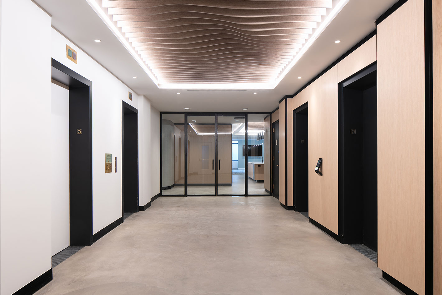 The wood-paneled elevator bank entry to the Work Better offices,