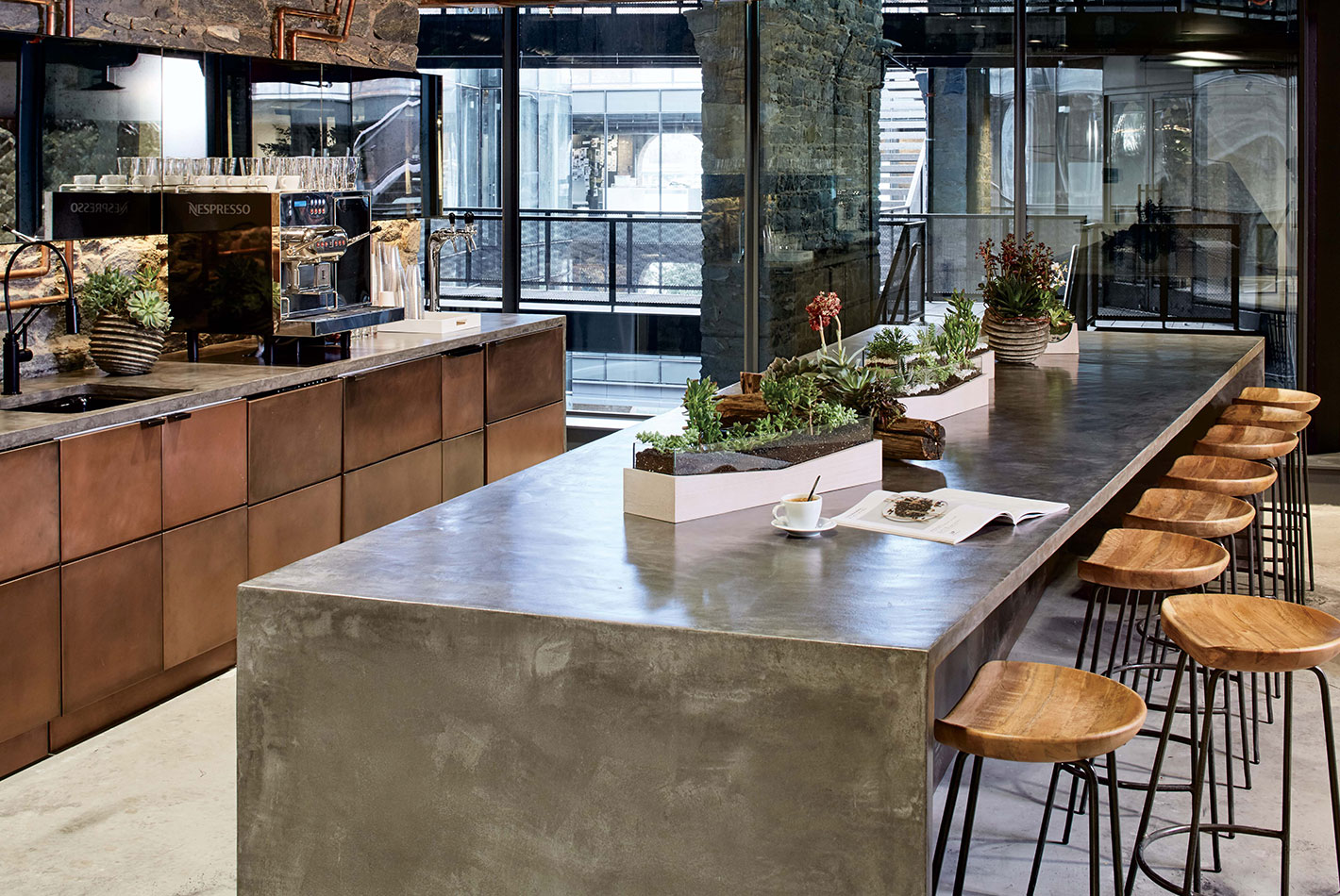 Polished concrete counters and copper-faced cabinets create a casual dining area at West Elm Headquarters.