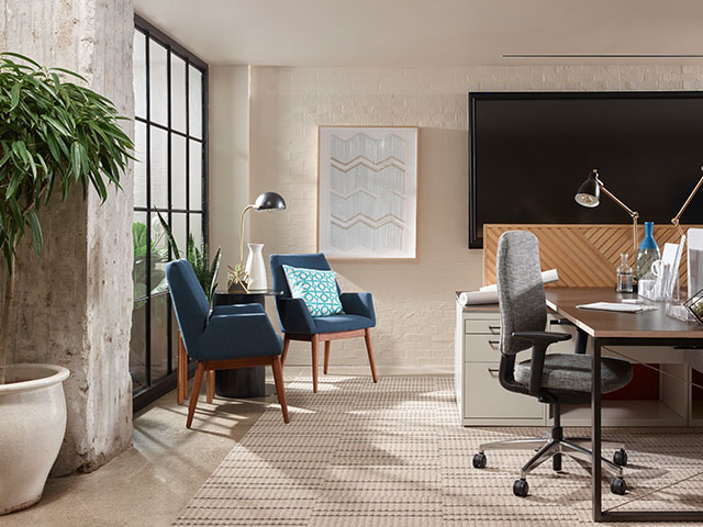 A desk and several upholstered side chairs in the West Elm NeoCon Showroom.