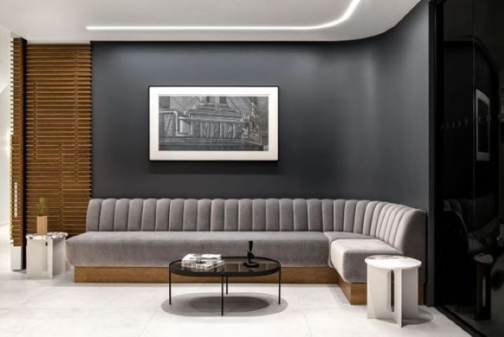 lobby entrance with banquette in grey velvet and grey walls